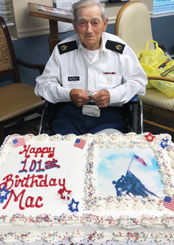 Resident Mac sitting in front of his 101th birthday cake
