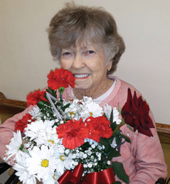 female resident of Hardinsburg with her mothers day flowers