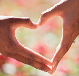 close up of hands making the shape of a heart