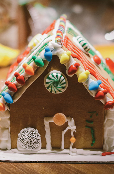 close up of homemade gingerbread house decorated with candy