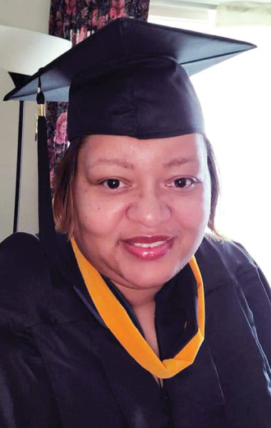 Hardinsburg Nursing and Rehab employee Marquita wearing her graduation cap and gown