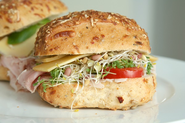 sandwich with tomato sprouts turkey and cheese